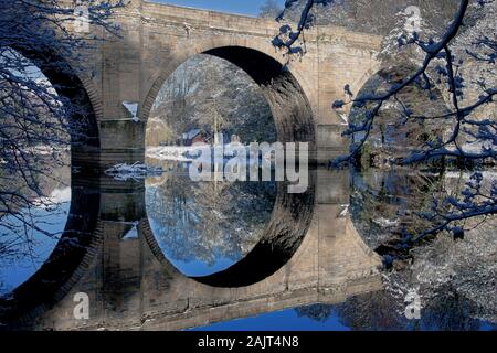 A daytime view of Prebends Bridge in Winter reflected in the River Wear, Durham City, County Durham, England, United Kingdom Stock Photo