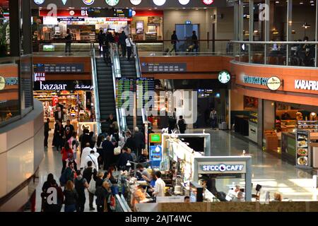 Istanbul Airport / Turkey - November 19 2019 Designer shops and Fast Food stores use bright neon signs and LED displays to tempt travellers Stock Photo