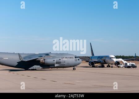 Pope Army Airfield, NC, USA. 5th Jan, 2020. Jan. 5, 2020 - POPE ARMY AIRFIELD, N.C., USA - A U.S. Air Force C-17 Globemaster III taxis past a contract carrier for U.S. Army paratroopers from the 1st Brigade Combat Team, 82nd Airborne Division, continue their deployment from Pope Army Airfield, North Carolina. The 'All American Division' Immediate Response Force (IRF), based at Fort Bragg, N.C., mobilized for deployment to the U.S. Central Command area of operations in response to increased threat levels against U.S. personnel and facilities in the area. TodayÃs deployment follows the Jan. Stock Photo