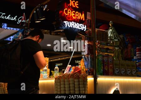 Istanbul Airport / Turkey - November 19 2019 Designer shops and Fast Food stores use bright neon signs and LED displays to tempt travellers Stock Photo