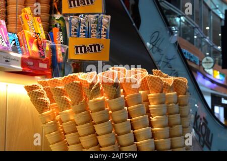 Istanbul Airport / Turkey - November 19 2019 Designer shops and Fast Food stores use bright neon signs and LED displays to tempt travellers Stock Photo