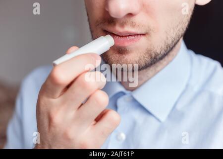 Man applying lip balm Stock Photo - Alamy