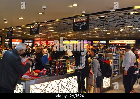 Istanbul Airport / Turkey - November 19 2019 Designer shops and Fast Food stores use bright neon signs and LED displays to tempt travellers Stock Photo