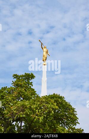 The golden Angel Moroni statue stands on top of a white spire located at the Seoul Korea Temple of the Church of Jesus Christ of Latter-day Saints. Stock Photo