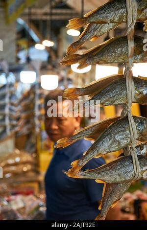 Dried fish hang in front of a fish monger at Gwangjang Market in Seoul, South Korea. Stock Photo