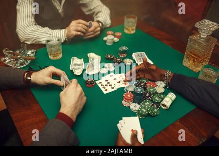 Male poker players at gaming table, casino Stock Photo