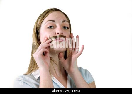 Portrait of white female playing with hair in front of a white background Stock Photo