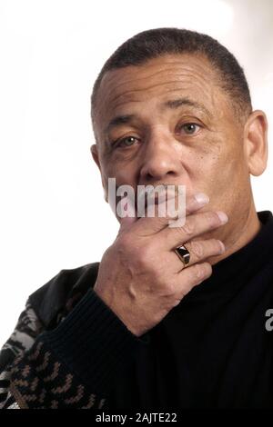 Portrait of a thoughtful African-American man with his hand on his chin on a white background Stock Photo