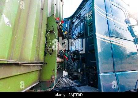 Big rig classic green semi truck with capacity compartment behind of tractor cab transporting bulk semi trailer Stock Photo