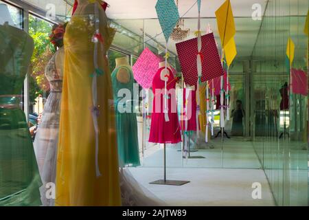 Colorful dresses in a shopfront window Stock Photo