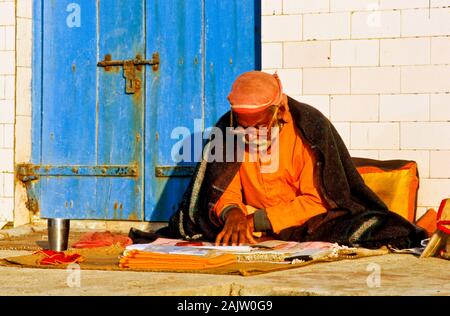 Old man studying the holy scriptures of Hinduism Stock Photo