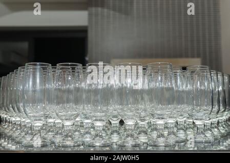 Empty and aligned crystal bowls over black granite. Stock Photo