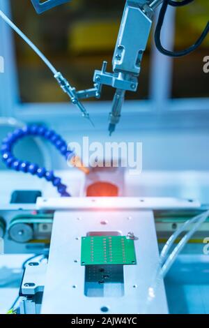 automatic soldering iron tips of robotic system for printed and assembly electric circuit board ( PCB ) at factory Stock Photo