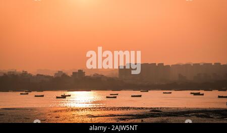 Panoramic silhouette of surat city while sun rising near ONGC bridge Stock Photo