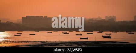 Panoramic silhouette of surat city while sun rising near ONGC bridge Stock Photo