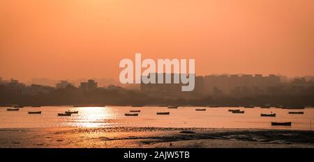 Panoramic silhouette of surat city while sun rising near ONGC bridge Stock Photo