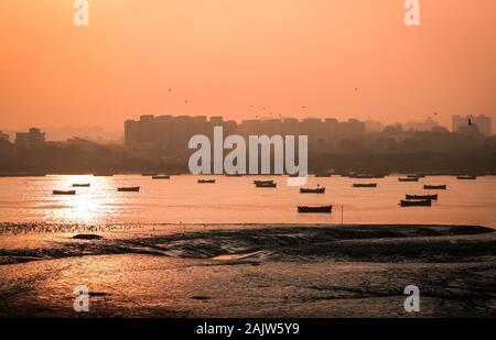 Panoramic silhouette of surat city while sun rising near ONGC bridge Stock Photo