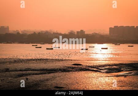 Panoramic silhouette of surat city while sun rising near ONGC bridge Stock Photo