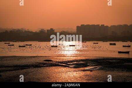 Panoramic silhouette of surat city while sun rising near ONGC bridge Stock Photo