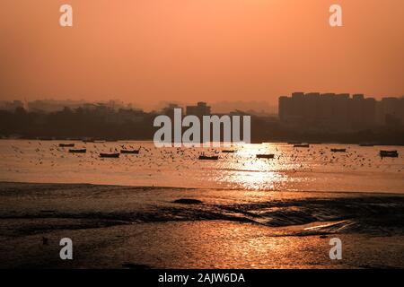 Panoramic silhouette of surat city while sun rising near ONGC bridge Stock Photo