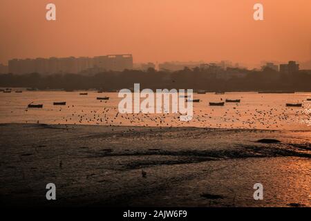 Panoramic silhouette of surat city while sun rising near ONGC bridge Stock Photo