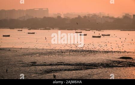 Panoramic silhouette of surat city while sun rising near ONGC bridge Stock Photo