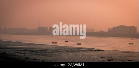 Panoramic silhouette of surat city while sun rising near ONGC bridge Stock Photo