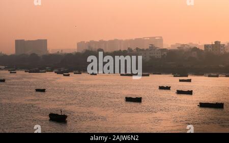 Panoramic silhouette of surat city while sun rising near ONGC bridge Stock Photo