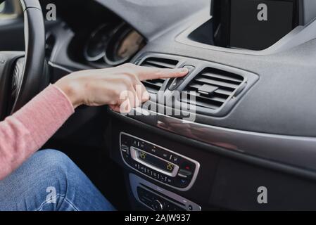 Woman hand press emergency stop button in the car Stock Photo
