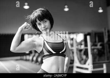 Young beautiful Asian woman working out at the gym Stock Photo