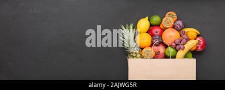 Supermarket paper bag Filled with fresh and tasty fruits. Healthy food. Stock Photo
