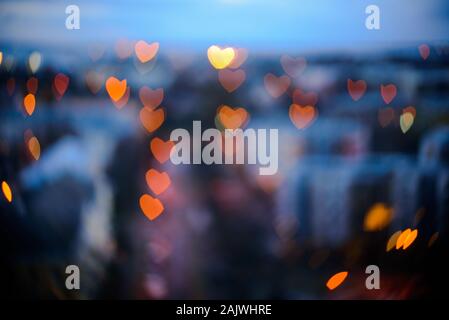 Heart-shaped city lights at morning. Blurred Stock Photo