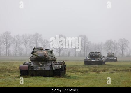 Abandoned derelict American tanks in a field with mist in Germany Stock Photo