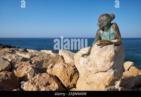 PAPHOS, CYPRUS - JUNE 08, 2018: Sol Alter by Yiota Ioannidou – a sculpture of young woman that pays homage to Aphrodite, on coastal Broadwalk. A part Stock Photo