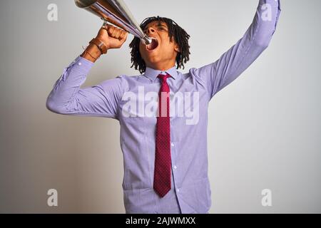 Young african american businessman screaming using vintage megaphone Stock Photo