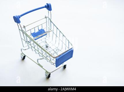Small supermarket grocery push cart for shopping  on white background. Stock Photo