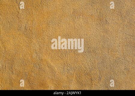 Background from a wall of ocre plaster Stock Photo