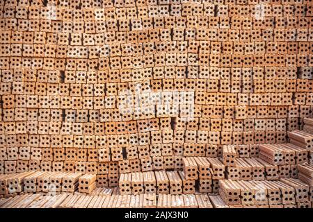 A group of construction brick or Pile of clay bricks put in neat order, used for construction material store outdoor at building site. Construction co Stock Photo
