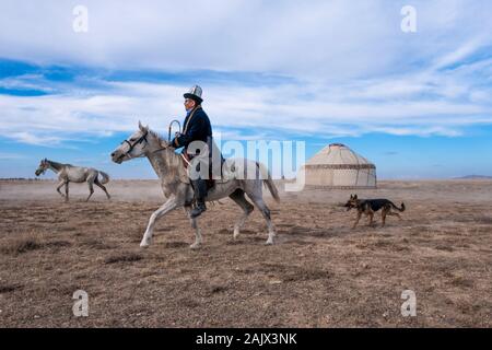 Horses running in Kyrgyz Village and traditional Kyrgyz tent Stock Photo