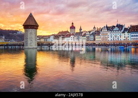 Dramatic sunset over historical Lucerne Old town, wooden Chapel bridge and Reuss river, Switzerland Stock Photo