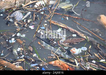 Plastic and microplastic waste floating in the water. Ocean and sea plastic pollution Stock Photo