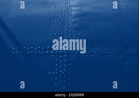 texture covering aircraft rivets for background. Classic blue toning trend 2020 year color Stock Photo