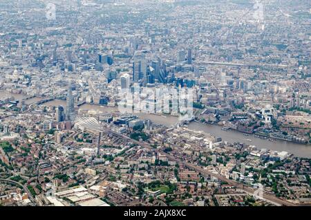 Aerial view of Southwark and the City of London with the River Thames flowing under Tower Bridge and the tower blocks of the Shard, Gherkin and the Ba Stock Photo