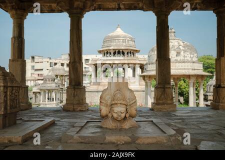 Sculpture of Hindu tripartite Gods under Royal cenotaph and surrounded by many cenotaphs in Udaipur, Rajasthan, India. Stock Photo