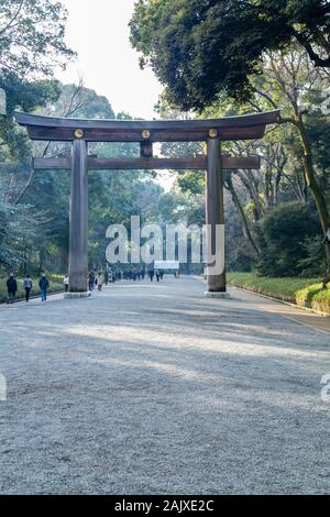 TOKYO, JAPAN - FEBRUARY 7, 2019: Unidentified people by torii gate of Meiji Shrine in Shibuya, Tokyo. The shrine is officially designated Kanpei-taish Stock Photo