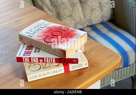 Atheist books piled on a table Stock Photo