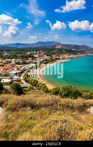 Greek holidays, beautiful Kalyves village with turquoise sea in Crete island, Greece. View of Kalyves beach, Crete. Tourists relaxing on the beach and Stock Photo