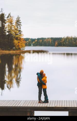 Hugging couple in love family lifestyle romantic dating relationship man and woman on pier outdoor travel in Finland  lake and autumn season forest la Stock Photo