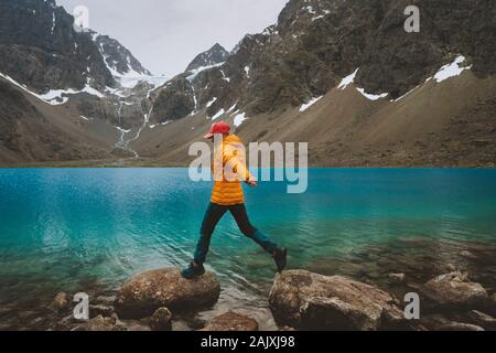 Woman hiking travel in Norway mountains with blue lake view adventure vacation healthy lifestyle outdoor tourism activity Stock Photo