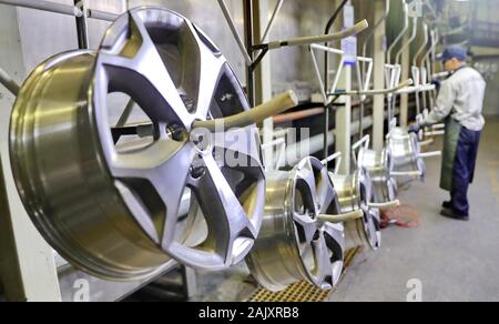 Aluminum car rims are manufactured on the production line at a rim ...